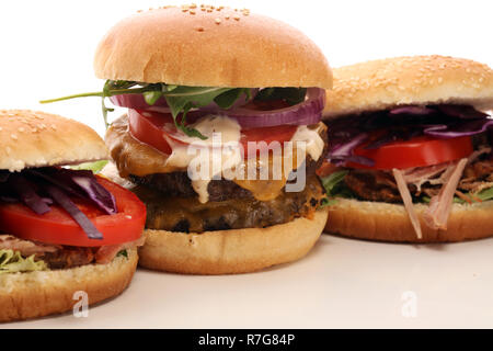 Tasty fresh meat burgers with salad and cheese. Homemade angus burger and Pulled pork sandwiches Stock Photo