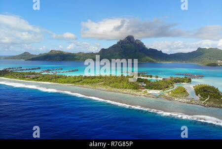 Aerial panoramic landscape view of the island of Bora Bora in French Polynesia with the Mont Otemanu mountain surrounded by a turquoise lagoon, motu a Stock Photo