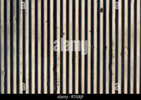 Old distressed painted chipped white wall with lines and shadows Stock Photo