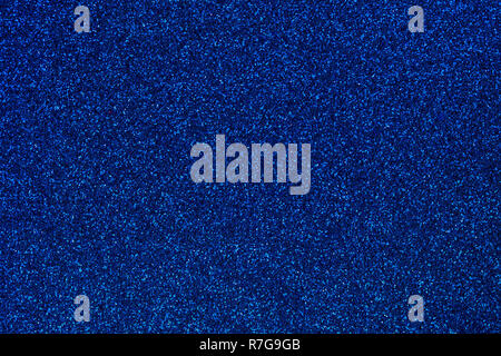 Navy blue colored sand paper textured background with sparkles and glitters Stock Photo