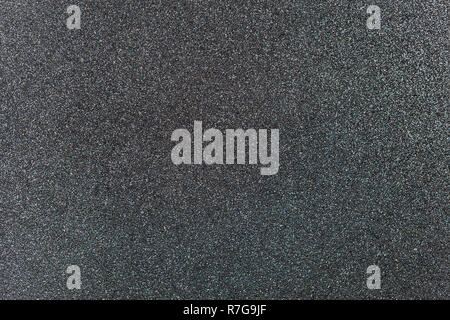 Charcoal grey colored sand paper textured background with sparkles and glitters Stock Photo
