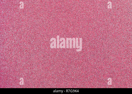 Rose pink colored sand paper textured background with sparkles and glitters Stock Photo