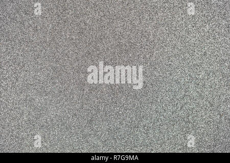 Dark silver colored sand paper textured background with sparkles and glitters Stock Photo