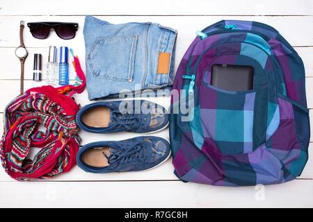 What to Pack in Your Carry On girl  Bag - backpack, money, glasses, shoes, jeans, accessories Stock Photo