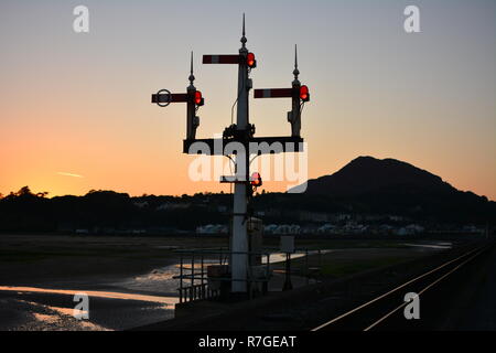 Ffestiniog Railway Trident Signal/Three Semphore on the Cob Porthmadog during a sunset Stock Photo