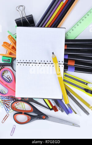 opened Notepad on office supplies on white background Stock Photo