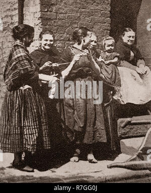 Life for working folk in Victorian days... Women dressed in traditional shawls get together for a knitting party, Liverpool, Merseyside, England Stock Photo