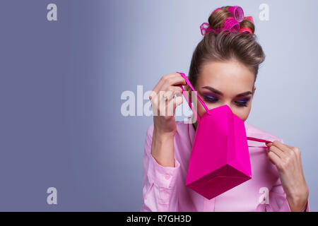 Shopping, sale, christmas and holiday concept - smiling woman with small shopping gift bag Stock Photo