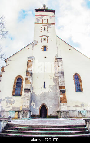 Basilica of the Holy Cross in Kezmarok city, Slovak republic. Religious architecture. Travel destination. Vivid photo filter. Stock Photo