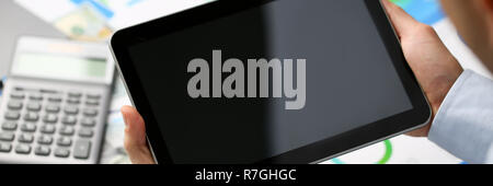 Businessman holds tablet on background Stock Photo