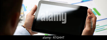 Businessman holds tablet on background Stock Photo