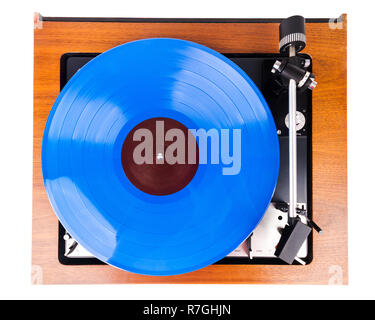 Vintage turntable with a blue vinyl isolated on white. Wooden plinth. Retro audio equipment. Stock Photo