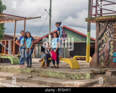 Atalaia do Norte, Brazil - September 21, 2018: Young people in blue school uniform on the street of village in the Amazon jungle. Stock Photo