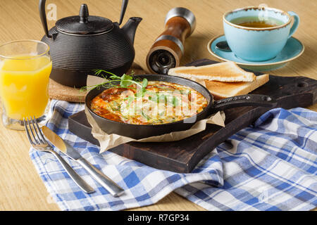 Omelet with vegetables and cheese. Frittata in a frying pan^ breakfast set Stock Photo