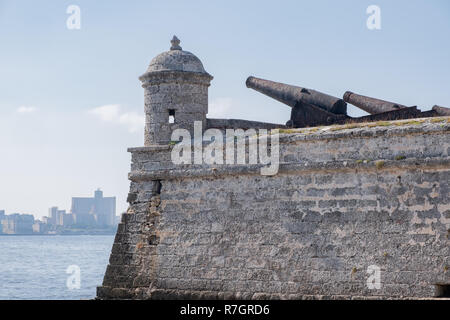 Old rusty cannons perched on Morro Castle point out over Havana Harbour. Stock Photo