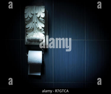 White toilet paper roll on chrome fixture with white antique plaster decoration above. Conceptual toilet design Stock Photo