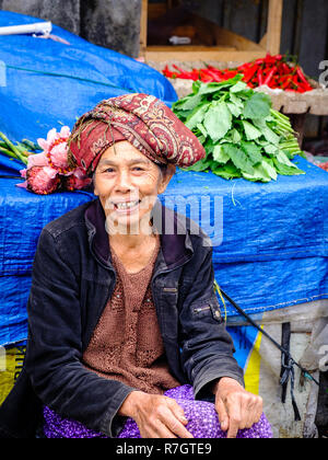 An elderly lady manning a market stall in Bali, Indonesia Stock Photo