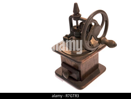 Old manual wooden coffee grinder with gear wheel isolated on white background Stock Photo
