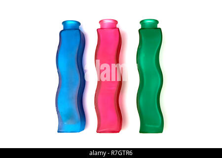 Three wavy glass flower vases of different colors isolated on white background Stock Photo