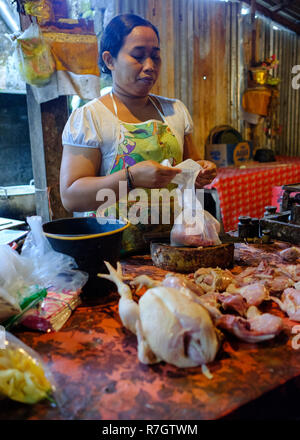 An elderly lady manning a market stall in Bali, Indonesia Stock Photo