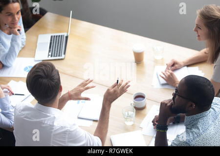 Top view diverse businesspeople negotiating sitting at boardroom Stock Photo