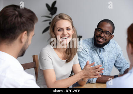 Millennial colleagues sitting at desk before business lecture Stock Photo