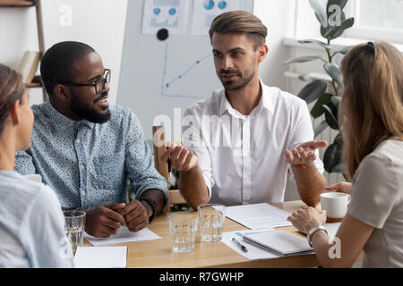 Diverse colleagues discussing during meeting in office  Stock Photo