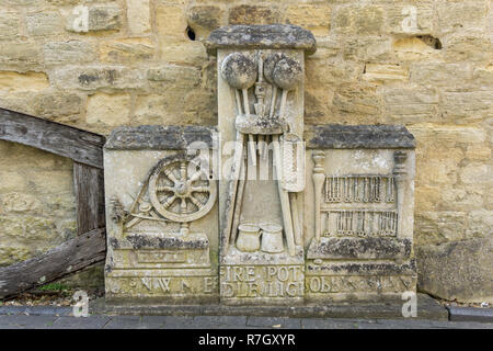 Stone carving, depicting tools of the lace making trade, rescued from the Lace Factory and now on view at the Cowper and Newton Museum, Olney, UK Stock Photo