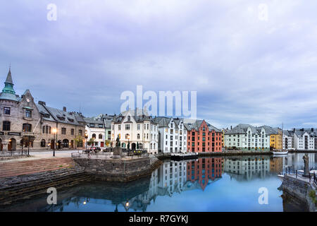 Alesun, Norway - July 20th, 2018: View of the Art Nouveau buildings reflected in the water at sunrise in summer, Alesund, Norway. Stock Photo