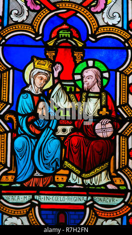 Stained Glass in the Cathedral of Monaco depicting the Coronation of Mother Mary by Jesus Christ in Heaven Stock Photo