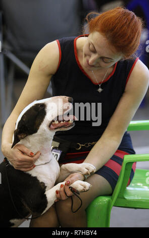 Kyiv, Kyiv, Ukraine. 9th Dec, 2018. Woman seen caressing her dog of the Bull Terrier breed during the Dog Show.Crystal Cup of Ukraine 2018 Dog show. Credit: Vadim Kot/SOPA Images/ZUMA Wire/Alamy Live News Stock Photo