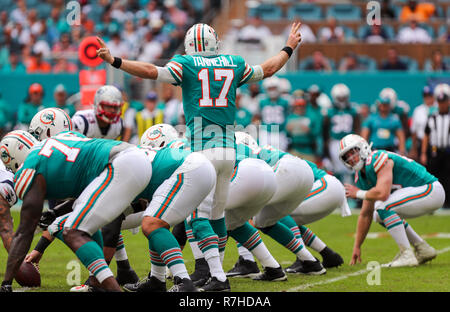 Miami Gardens, Florida, USA. 9th Dec, 2018. New England Patriots  quarterback Tom Brady (12) releases a pass challenged by Miami Dolphins  defensive tackle Akeem Spence (93) during an NFL football game between