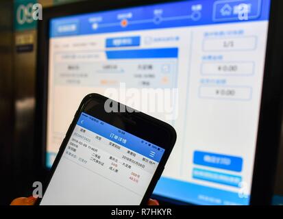 (181210) -- BEIJING, Dec. 10, 2018 (Xinhua) -- Zhang Yuliang gets ticket which she bought from an app on cellphone in Chongqing Municipality, southwest China, Feb, 9, 2018. China's internet service and related sectors maintained sound growth in the first 10 months of the year, seeing a stable market expansion of online streaming apps, data showed. The sectors' revenue totaled 766.3 billion yuan (about 111.6 billion U.S. dollars) in the Jan.-Oct. period, up 18 percent year on year, according to the Ministry of Industry and Information Technology (MIIT). From January to October, Guangdong, Stock Photo