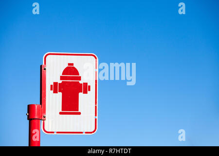 Typical North American  road sign indicating the presence of a fire hydrant taken in a street of Montreal, Quebec, Canada, with its typical red hycon, Stock Photo