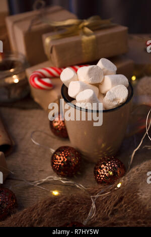 Christmas decor. still life with vintage details and Christmas decor. toy, garland and cup with hot drink and marshmallow on vintage wooden background Stock Photo