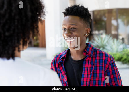 African american young adult man talking with friend outdoor in the city Stock Photo