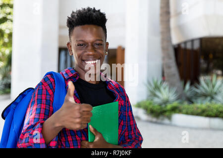 Successful african american male student with book outdoor in the city Stock Photo