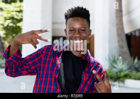 Happy posing african american young adult man outdoor in the city Stock Photo