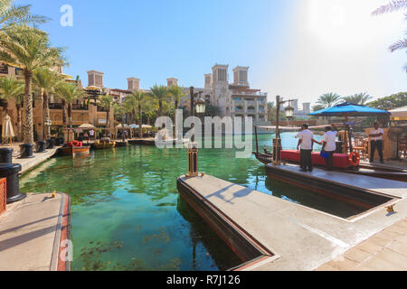 DUBAI, UAE - NOV 12, 2018: arabic architecture in Dubai souk Madinat Jumeirah with locals waiting for tourists to take by boat to visit Burj al Arab Stock Photo