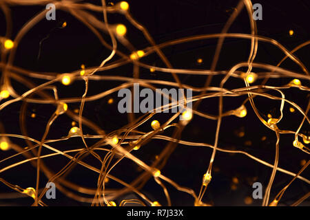 christmas led lights macro shot, warm shining fairy light garlands extreme close up view background for christmas and new years eve Stock Photo