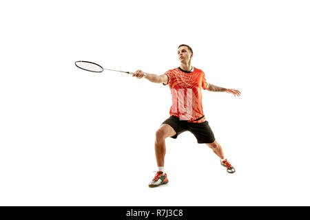 Young man playing badminton over white studio background. Fit male athlete isolated on white. badminton player in action, motion, movement. attack and defense concept Stock Photo