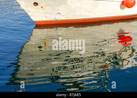 Boats reflecting in the water in a harbour Stock Photo