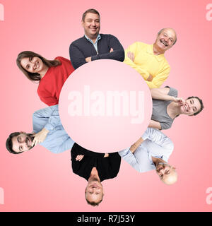 Several smiling positive european men and women in circle over pink backgrpund. Stock Photo