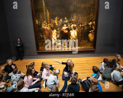 Schoolchildren visitors at The Night Watch painting by Rembrandt van Rijn at the Rijksmuseum in Amsterdam, The Netherlands Stock Photo