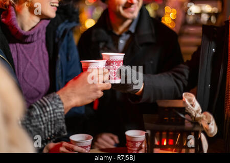 Close up image of two friends cheering at Christmas market, Zagreb, Croatia. Stock Photo