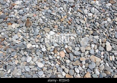 Pebbly beach background from Crete, Greece. Shingle beach. Stock Photo