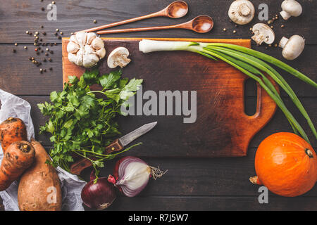 Ingredients for vegetable vegetarian soup on a dark wooden background, top view. Stock Photo