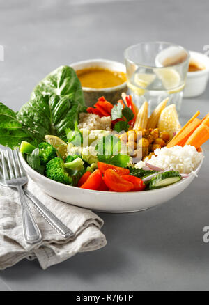Vegan buddha bowl on gray concrete table. Healthy vegan food concept Stock Photo