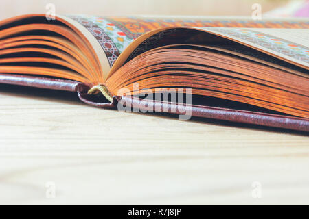 open book on the wooden table with copy space, selective focus and shallow depth of field Stock Photo