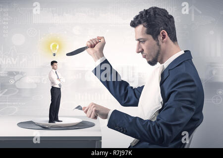 Giant businessman eating small man with financial background  Stock Photo